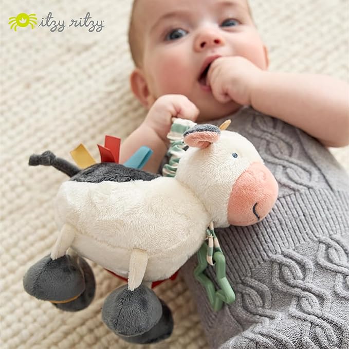 Itzy Ritzy Link & Love Toy for Stroller or Car Seat; Features Textured Ribbons, Crinkle Sounds, Clinking Rings & Silicone Teether; Designed for Ages 0 Months and Up (Cow)